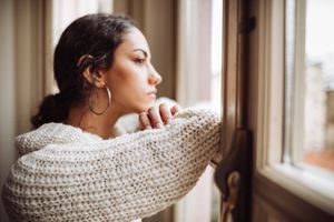 sad woman looking out the window