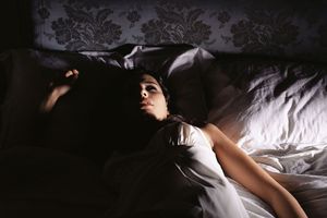 Woman lying on the bed at night