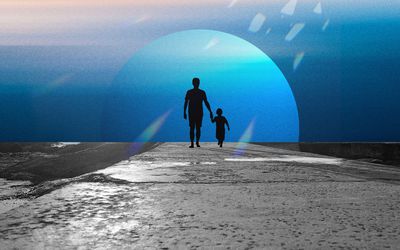 Child walking with father on a paved path with a moon backdrop