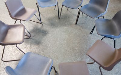 Empty chairs in a circle for AA meeting