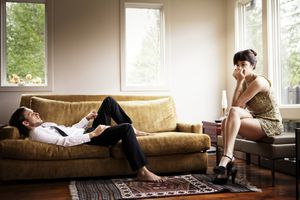 Unhappy couple sitting in a living room