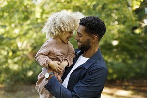 Father and daughter in park, having fun together