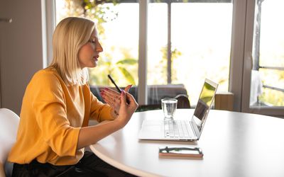 Young woman doing online therapy on her laptop