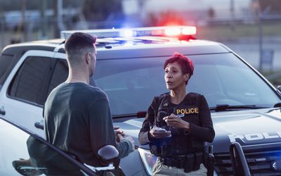 policewoman taking a statement from young man