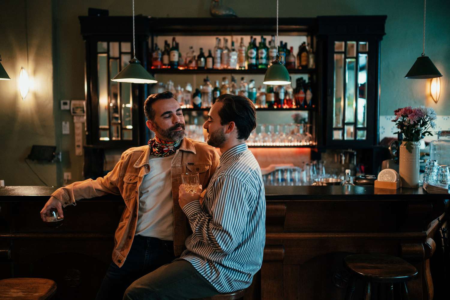 gay couple sitting in a bar