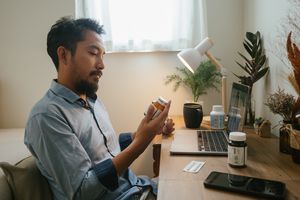 A person with a medication bottle