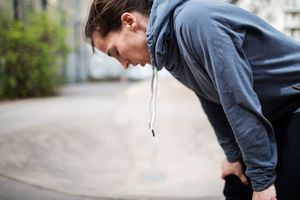 Woman bending over breathing deeply