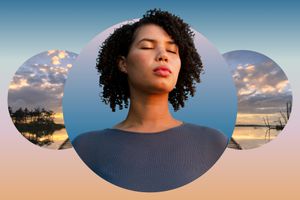 Woman meditating against a cloudy sky backdrop