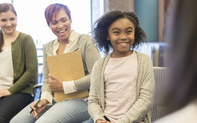 Young girl talks with school counselor