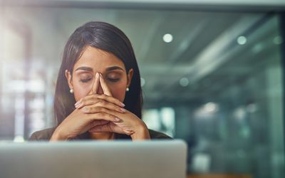 young businesswoman looking stressed out while working in an office