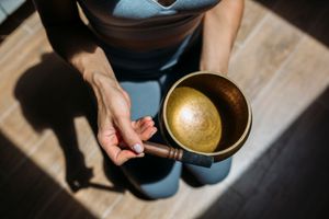 Woman playing singing bowl