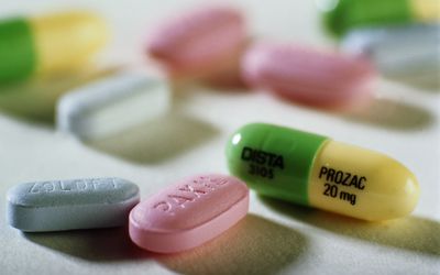 Close-up of Prozac, Paxil, and Zoloft tablets.