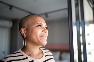 Woman with bipolar disorder looking out window.