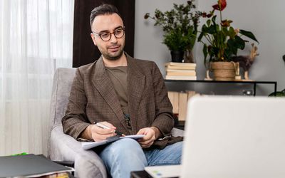 Male psychiatrist in online therapy session with his patient about eating disorders