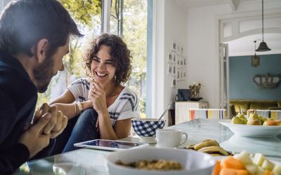 happy couple talking over breakfast