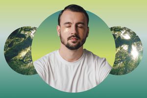 Man closing his eyes meditating against a rainforest backdrop