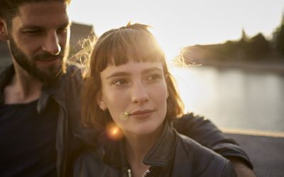 young woman with a handsome man on a boat looking off into the distance