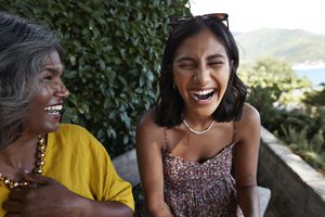 Cheerful female friends laughing together during weekend party