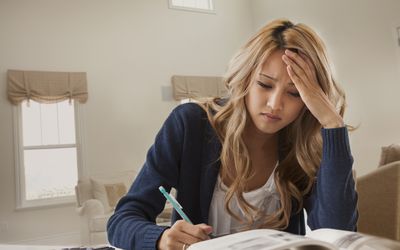 Woman reading, looking stressed