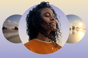 Woman meditating and smiling against a beach backdrop