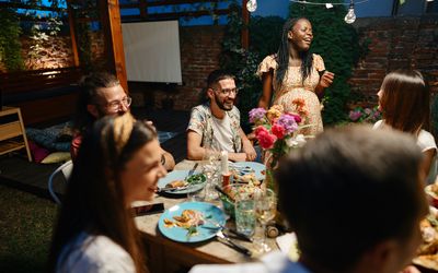 Friends and family having garden dinner party in the summer