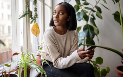 Woman at home looking outside window