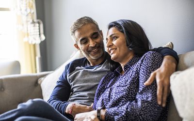 husband and wife embracing on the couch