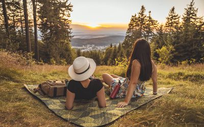 Two Young Happy Girls on Picnic, Laughing, Drinking water, Having Fun