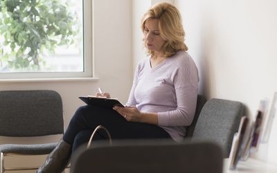 Woman completing questionnaire