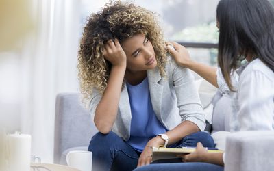 Depressed young woman talks to therapist