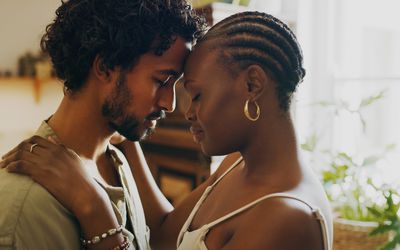 BIPOC couple showing affection with their foreheads touching