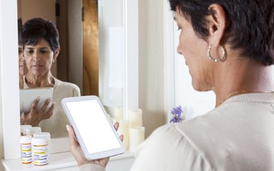 Woman researching medicine on a cell phone