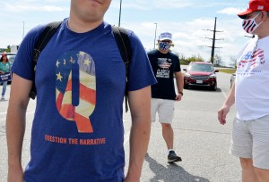 A man wears a QAnon shirt while boarding a shuttle bus at the Manchester Mall going to Manchester Airport in Londonderry, New Hampshire on August 28, 2020. (JOSEPH PREZIOSO/AFP via Getty Images)