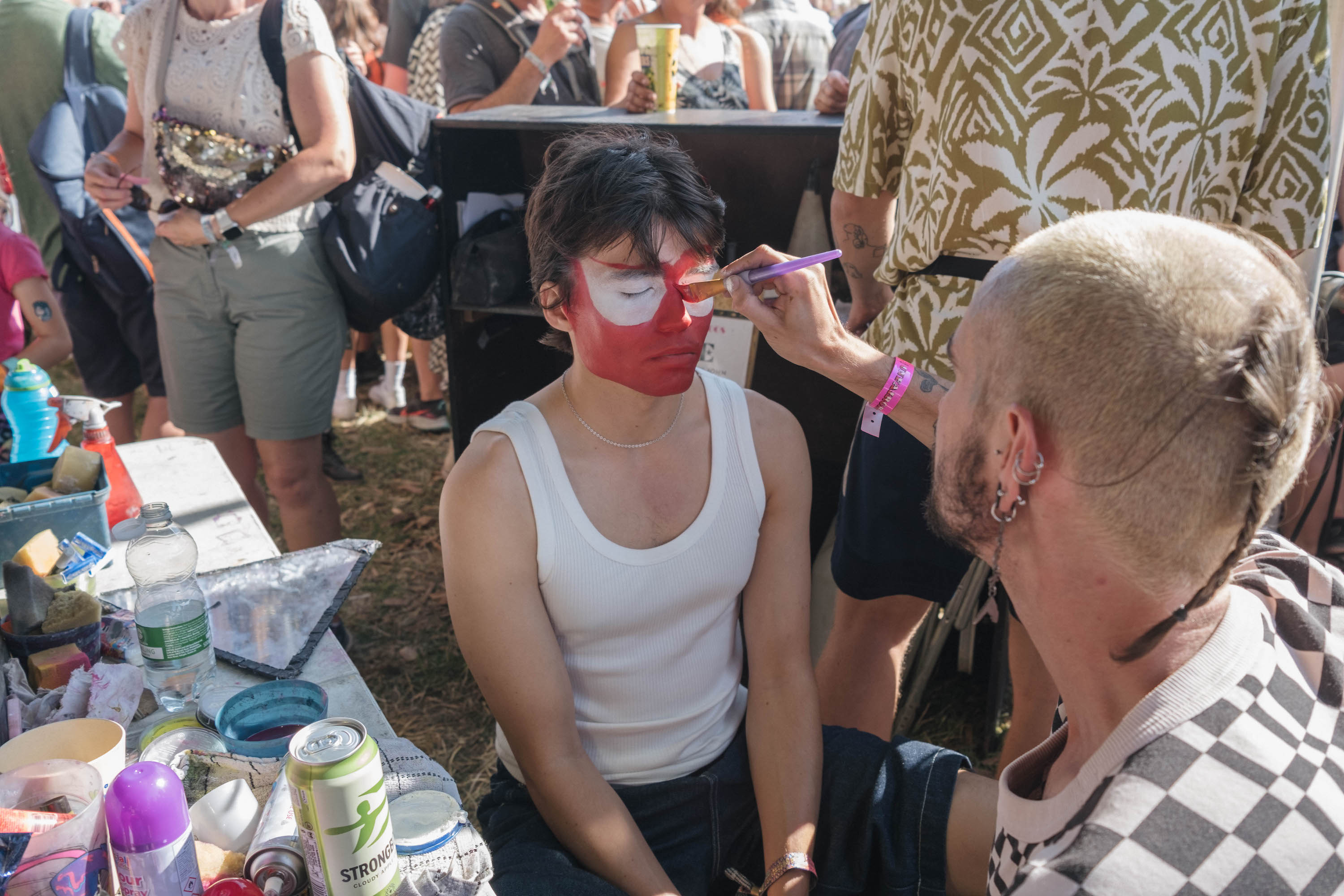 Snake Denton getting his face painted at Glastonbury