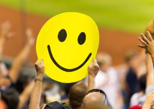 Sports fans wave a sign at a baseball game