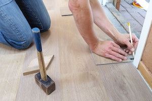 person measuring in door frame