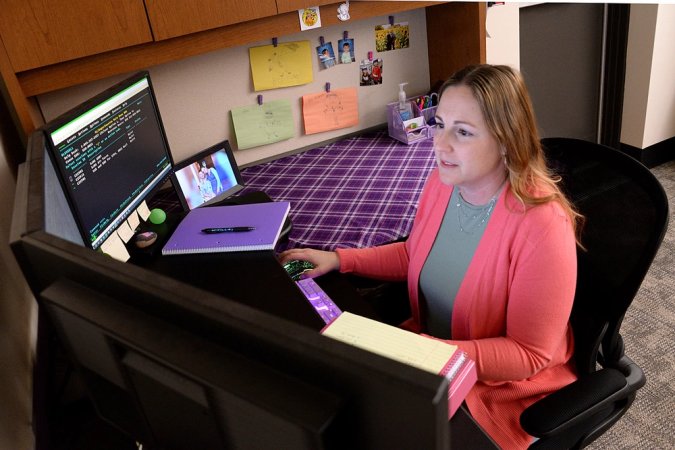 a woman works on her laptop