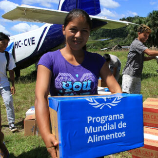 Girl holding relief supplies transported by WFP for COVID-19 response to affected populations in Ecuador