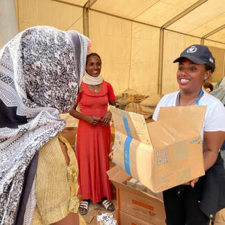 WFP staff giving nutritious food items to an Ethiopian woman