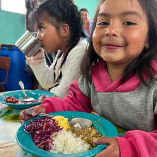 Two girls are eating school meals 