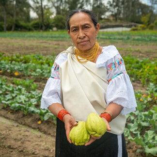 A woman farmer is showing her harvest