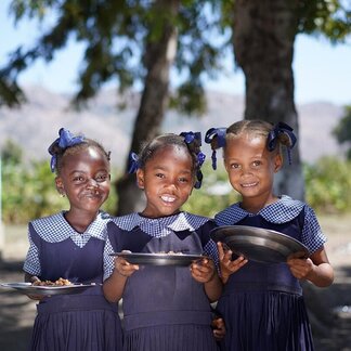 Pupils of Saint Raphael school with hot nutritious meals provided by WFP. WFP/Antoine Vallas