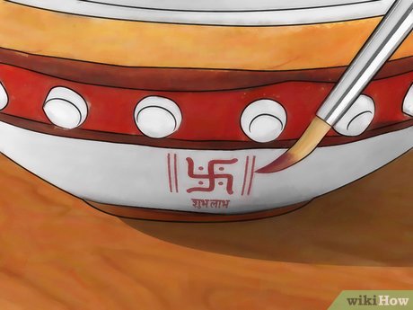 Step 2 Paint the symbols of Shubh Labh and Swastika on your diya.