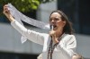 Opposition leader Maria Corina Machado displays vote tally sheets during a protest against the reelection of President Nicolás Maduro one month after the disputed presidential vote which she says the opposition won by a landslide, in Caracas, Venezuela, Wednesday, Aug. 28, 2024. (AP Photo/Cristian Hernandez)