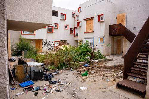 NIC ADAM / FREE PRESS
                                Centre Village, an inner-city subsidized housing complex once lauded for its design that was left to rot and became a hub for criminal activity, caught fire Wednesday night amid concerns about squatters and criminal activity there. We have a photo of police taking away a woman from the scene. Neighbouring residents have long been concerned. In May, Manitoba Housing donated the site to the Winnipeg Housing Rehabilitation Corp., a non-profit organization founded in the late 1970s to develop affordable housing. The May announcement was supposed to be held in April, but it was delayed after a body was found at the site (wasn’t deemed criminal at the time but we’ll check again). Reaching out to the province, neighbours/area biz/organizations, area city councillor and police. Is this what happens when a building is left to sit vacant for too long?