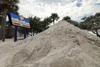 FILE - Sand washed ashore by the surge of Hurricane Helene is piled, Oct. 2, 2024, in Treasure Island, Fla. (AP Photo/Mike Carlson, File)