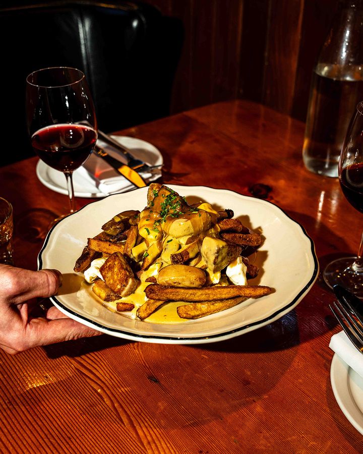 Martin Picard's legendary Montreal restaurant serves an ultra-decadent poutine topped with foie gras (Credit: Scott Usheroff)