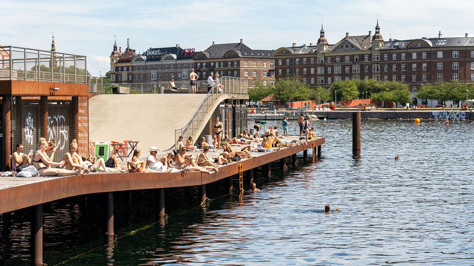 People enjoying the sun at Kalvebod Wave (Credit: Getty Images)