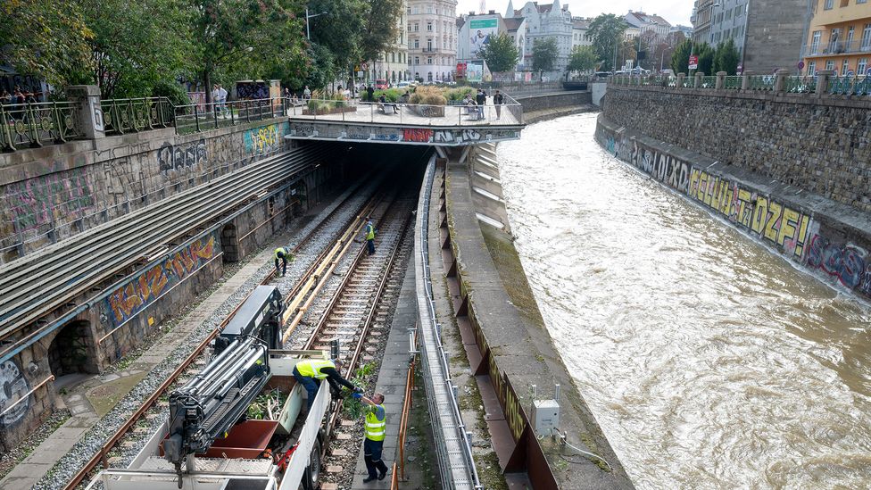 Workers clean up debris from subway tracks after the Wienfluss canal in Vienna spilled over its banks after Storm Boris (Credit: Getty Images)