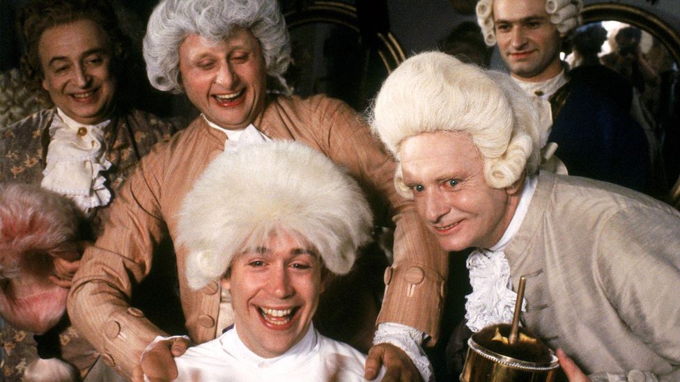 Tom Hulce and cast in a scene of Amadeus (Credit: Alamy)